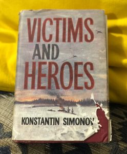 picture of the novel victims and heroes by konstantin simonov, sitting on a yellow cushion